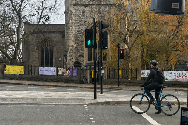 A cyclist adhering to the rules at the crossing near St. Mary's Church