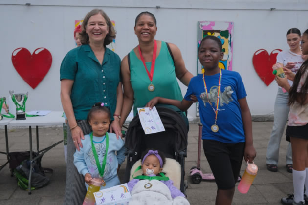 Fleur Anderson with local parent Orleen and her family after completing the Run, Scoot and Walk